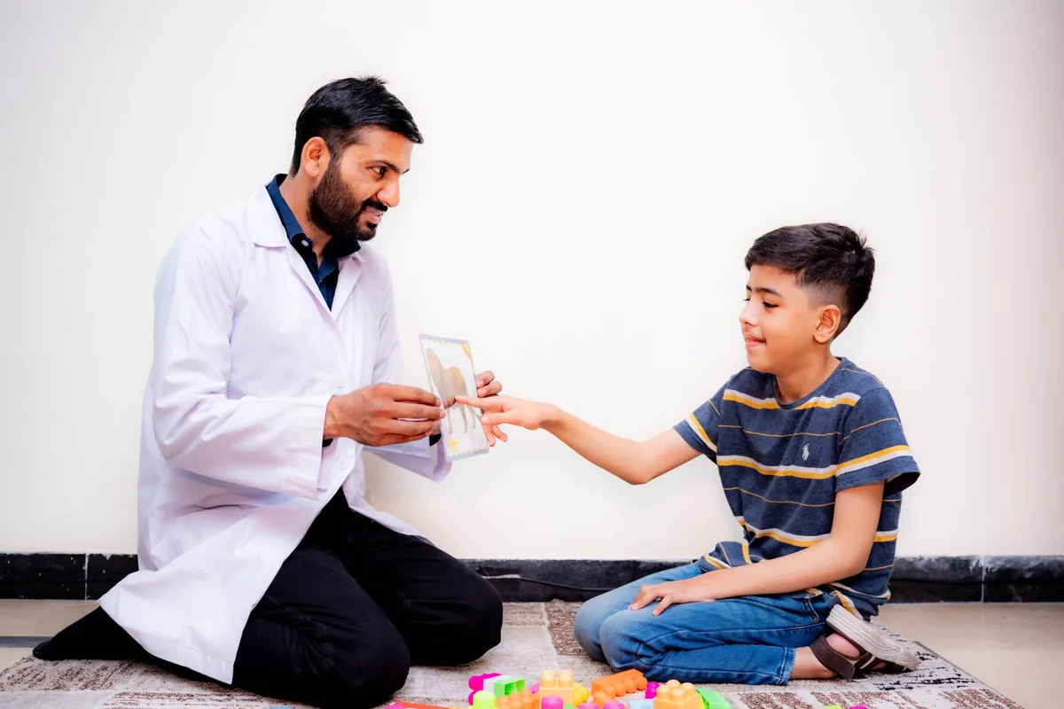 Speech therapist working with a child during a speech therapy session at Speech Rehab Clinic